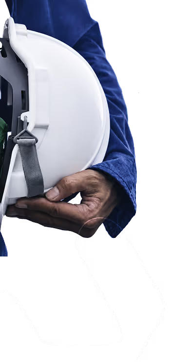 Hand holding a white safety helmet against a blue outfit background.